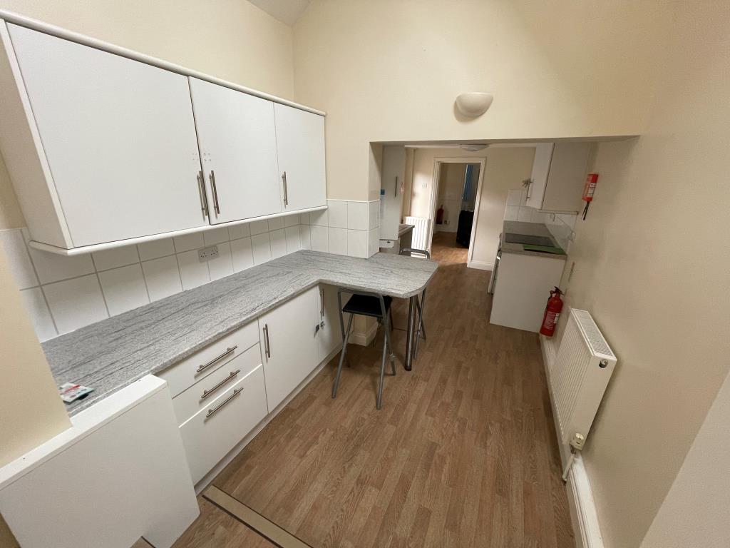 Lot: 98 - TWO FLATS AND ANNEX IN VILLAGE LOCATION - Kitchen with fitted units and access to garden